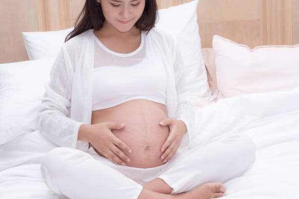istock pregnant woman touch her belly 940524910