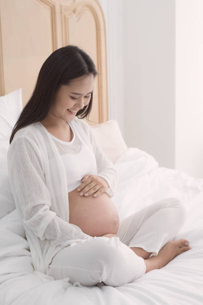 istock pregnant woman touch her belly 940524962