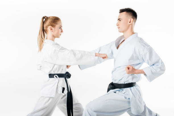 istock side view of karate fighters exercising in kimono isolated on white 940532418