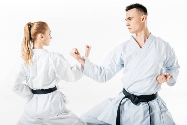 istock karate fighters showing block with hands isolated on white 940532502