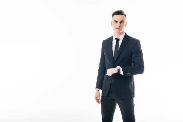 istock handsome businessman standing with wristwatch isolated on white 940536042