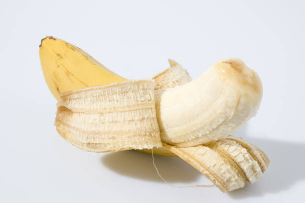 istock Yellow banana with peel in a white background composition 940536102