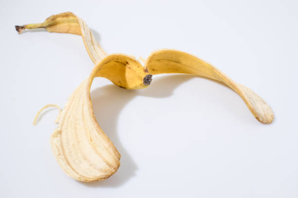 istock yellow banana peel in a white background composition 940536138
