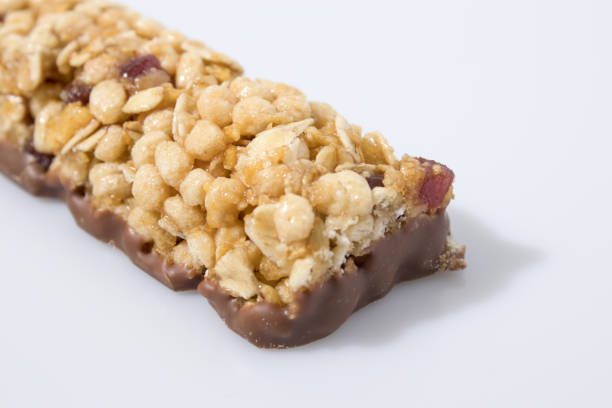 istock Cereal bar  whit fruit and chocolate in a white background composition 940536156