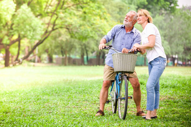istock Senior couple walking their bike 940538686