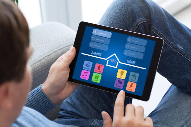 istock man in jeans holding tablet with app smart home screen 940543674