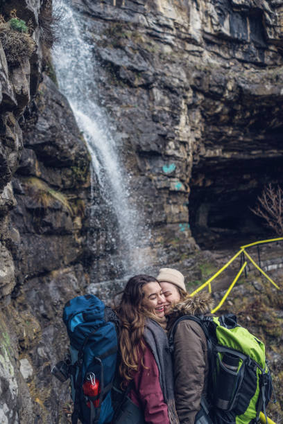 istock Girlfriends walking nearby waterfall in the mountains 940543866