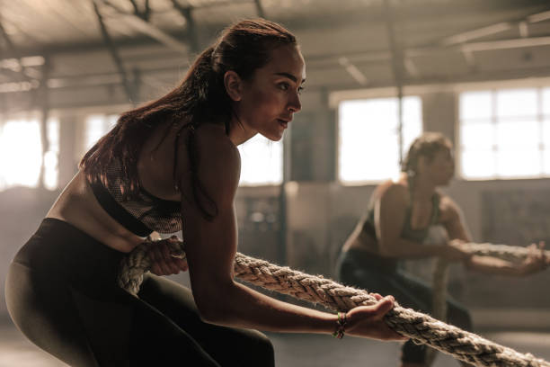 istock Women exercising with rope at a gym 940552208