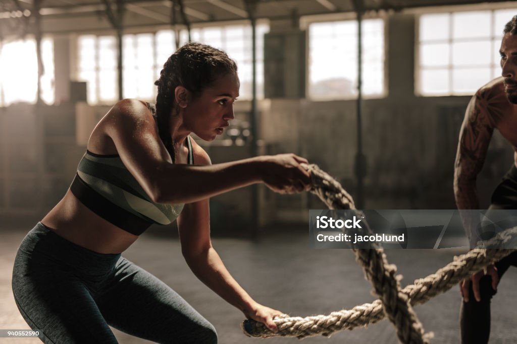 Femme faisant bataille corde séance d’entraînement au gymnase - Photo de Exercice physique libre de droits