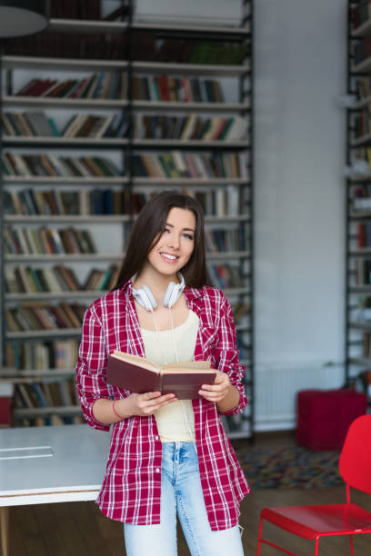 istock Teenager in a library 940552714