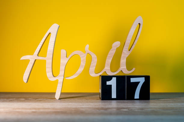 April 17th. Day 17 of month, calendar on wooden table and green background. Spring time, empty space for text April 17th. Day 17 of month, calendar on wooden table and green background. Spring time, empty space for text. number 17 stock pictures, royalty-free photos & images