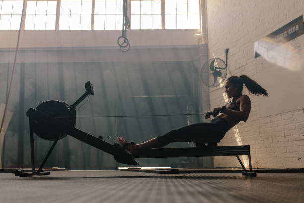 Woman doing cardio workout on rowing machine