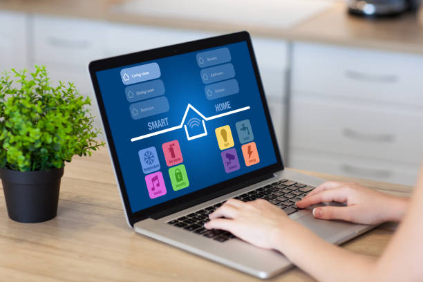 istock woman hands in laptop with app smart home room kitchen 940555332