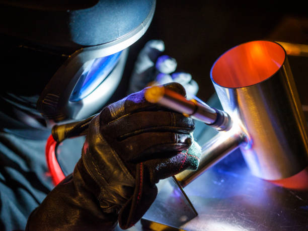 TIG Welder at Work A man using a TIG (Tungsten Inert Gas) welder in a workshop. metalwork stock pictures, royalty-free photos & images
