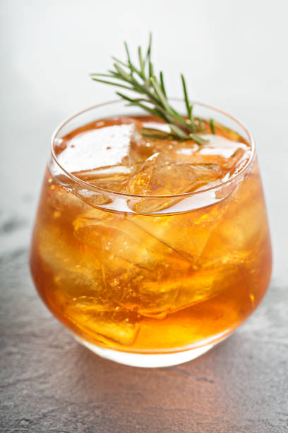 istock Old fashioned cocktail with ice and rosemary 940556950