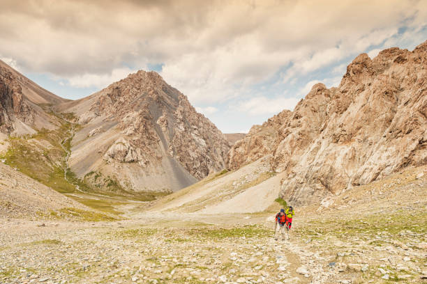 istock Two man hiking up the steep mountain 940559906