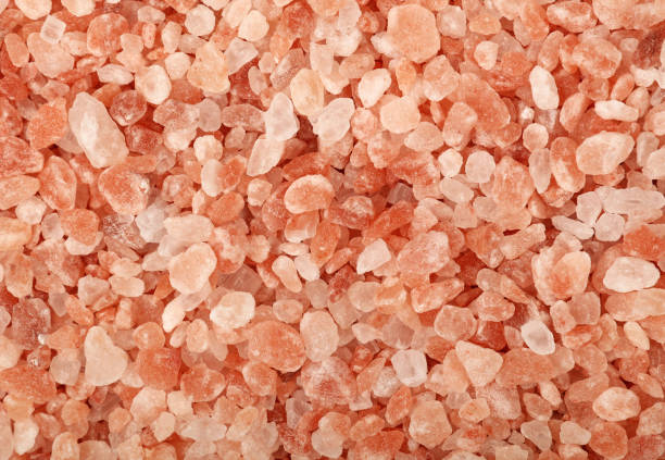 istock Close up background of pink Himalayan salt 940560634