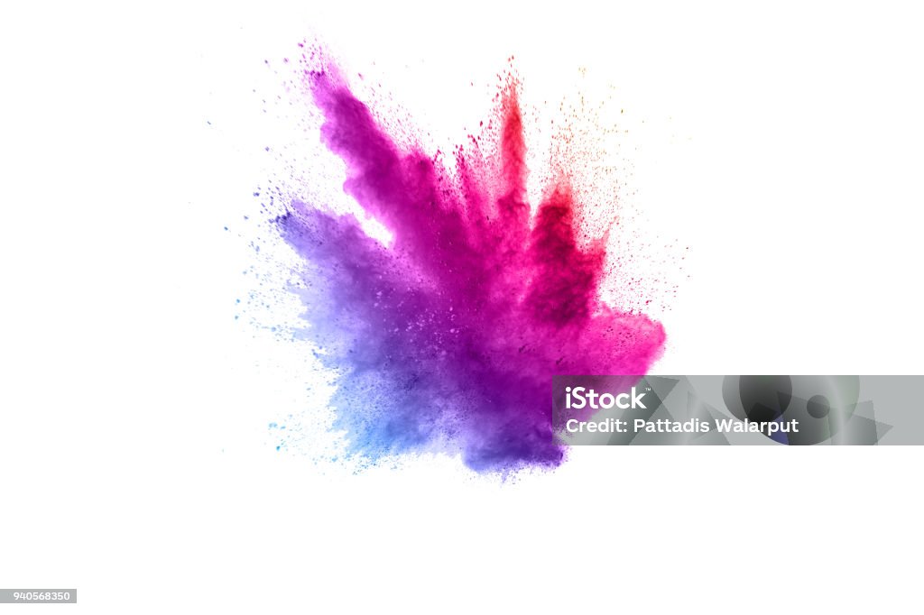 Abstract multicolored powder explosion on white background.  Freeze motion of color dust  particles splash. Painted Holi Exploding Stock Photo