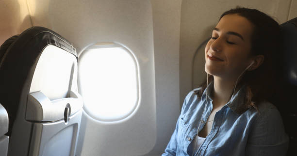 istock Confident woman relaxes during commercial flight 940568428