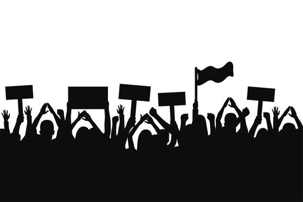 istock Crowd of protesters people. Silhouettes of people with banners and with raised up hands. Concept of revolution and political or social protest 940573544