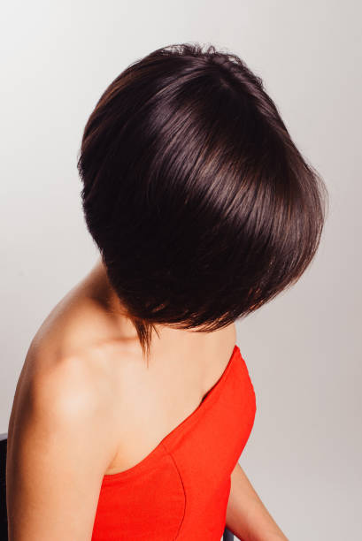 istock Brunette in a red dress with flowers on a white background 940577258