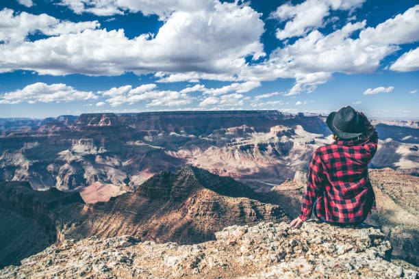istock Young Woman Overlooking The Grand Canyon 940582614
