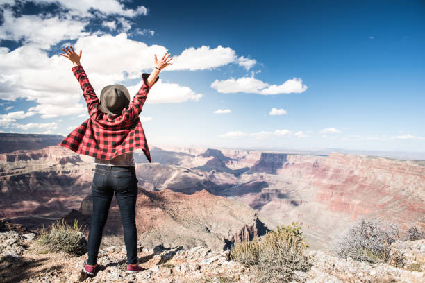 istock Young Woman Overlooking The Grand Canyon 940582618