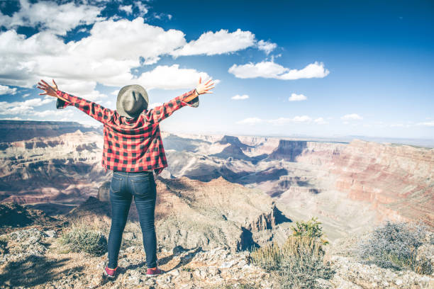 istock Young Woman Overlooking The Grand Canyon 940582626