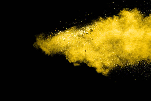 istock abstract yellow dust explosion on  black background. abstract yellow powder splatter on dark background. Freeze motion of yellow powder splashing. 940587674