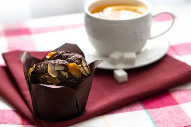 Photo of Tea with lemon and chocolate muffin