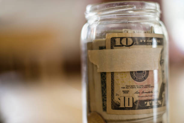 istock Glass Jar Filled with U.S. Currency 940590804