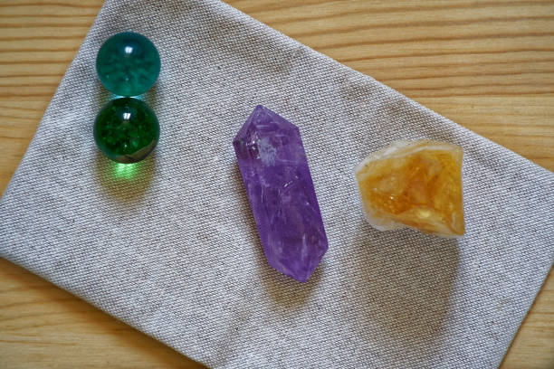 istock Crystals on linen fabric surface, mock-up for postcard or background for website and mobile devices Gems colored in royal purple, autumn maple and golden lime colors 940593346