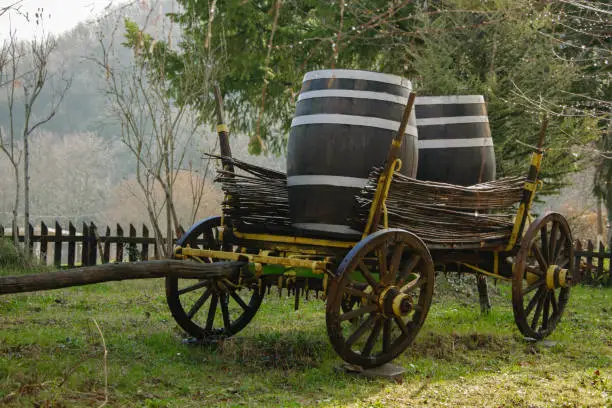 Photo of Antique cart for transporting goods - with two wine or beer barrels on top