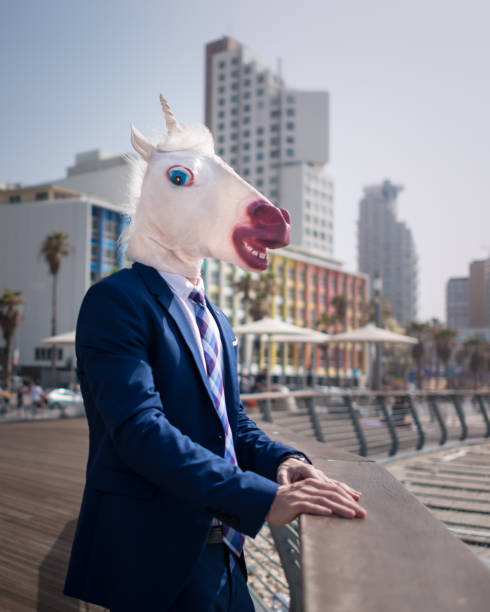 istock Strange young man stands on city promenade 940598584