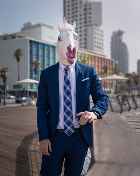 istock Young man in elegant suit stands on the city waterfront 940598594