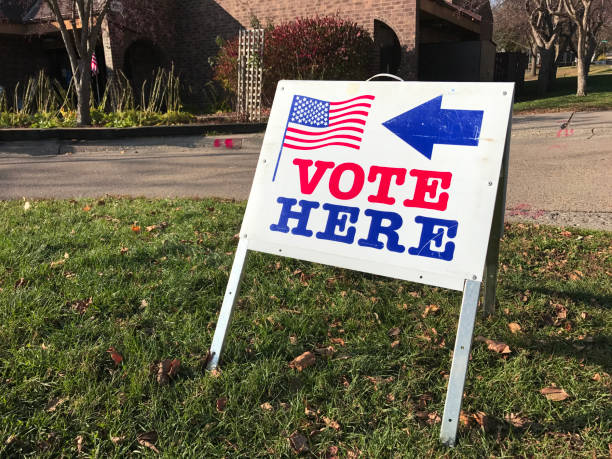 The voting location for political polling place. A sign pointing to the location building for casting vote ballot in United States