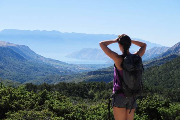 istock Young woman enjoying the mountain / seaside view 940600108