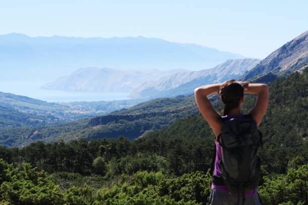 istock Young woman enjoying the mountain / seaside view 940600182
