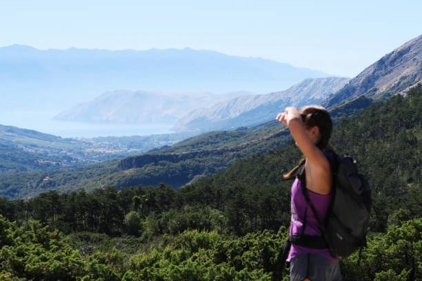 istock Young woman enjoying the mountain / seaside view 940600192