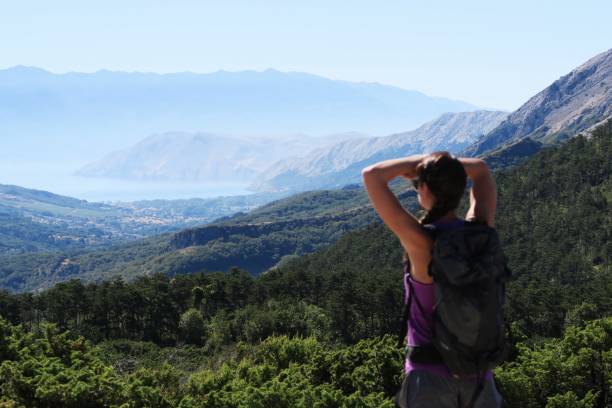 istock Young woman enjoying the mountain / seaside view 940600218