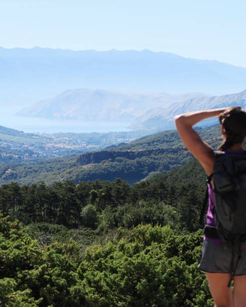 istock Young woman enjoying the mountain / seaside view 940600262
