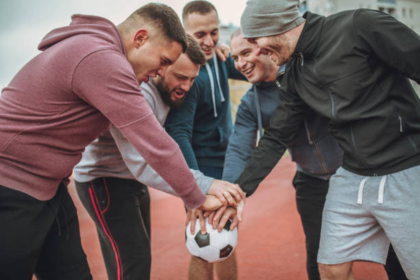 istock Football team huddling together 940611332