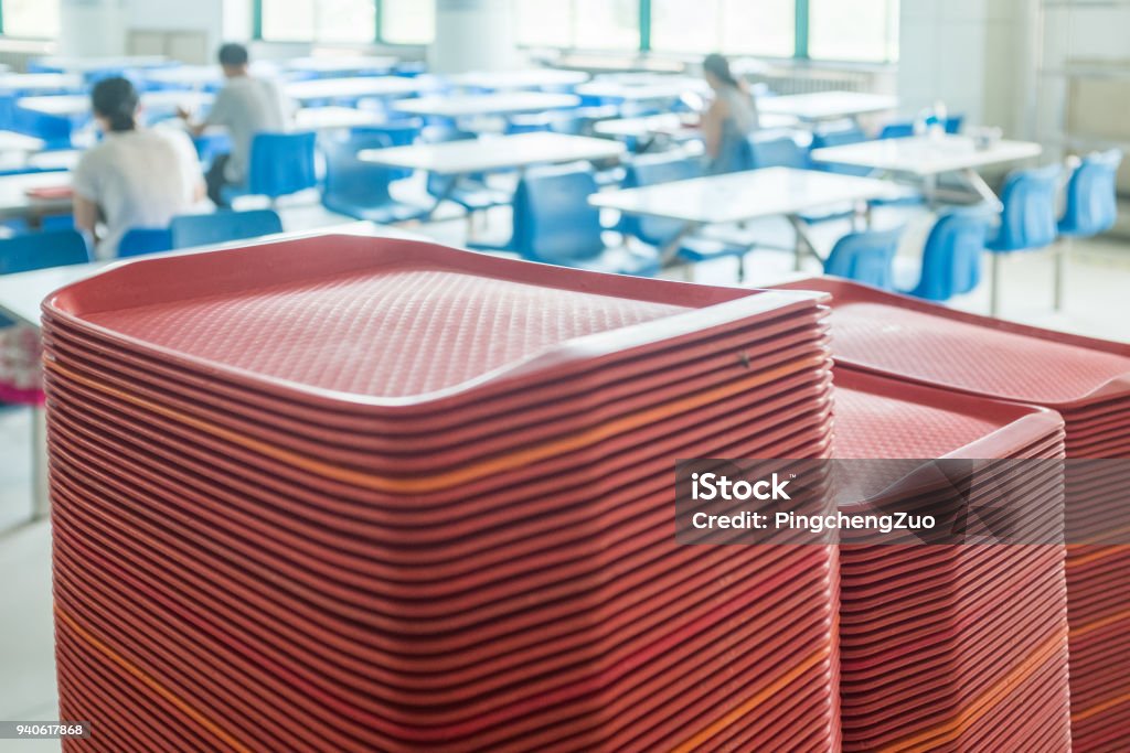 red plates in mess hall Cafeteria Stock Photo