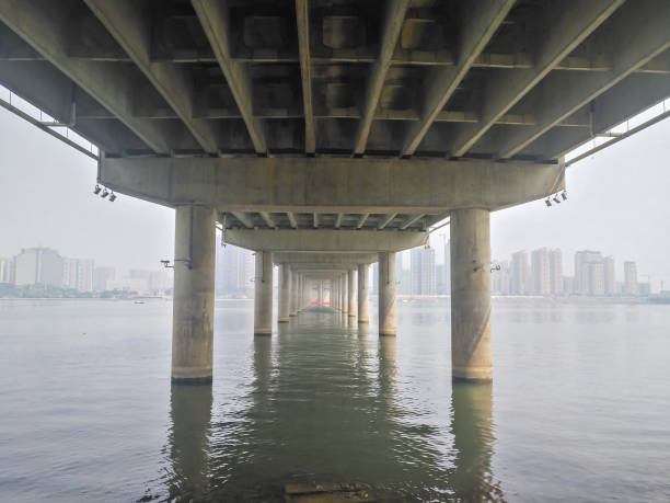 istock bottom of a big bridge cross the river 940618004