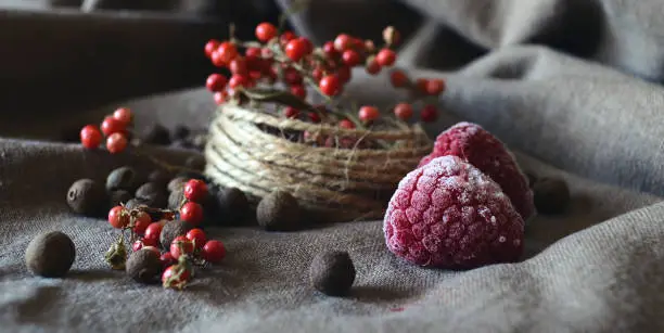 Still life with red berries and raspberry