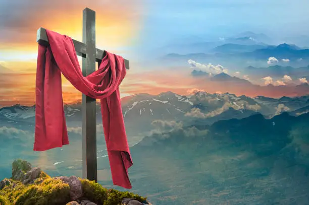 Photo of Christian cross against the sky over the mountains