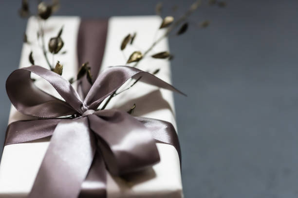 Gift box handmade from white paper, dry twigs, spruce. New Year Christmas.