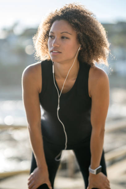 istock Woman taking a break while running outdoors 940636414