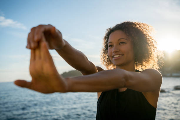 istock Happy woman exercising at the beach 940636452