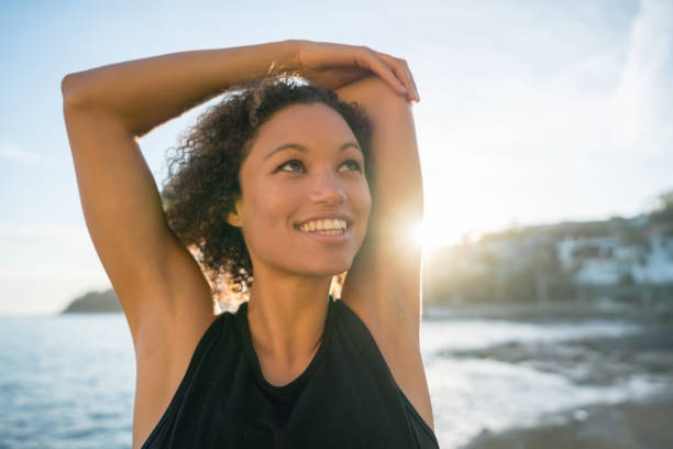 istock Woman doing yoga exercises at the beach 940636478